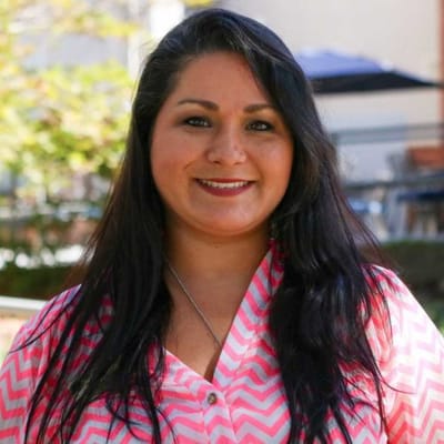 Staff member smiling in an outdoor area