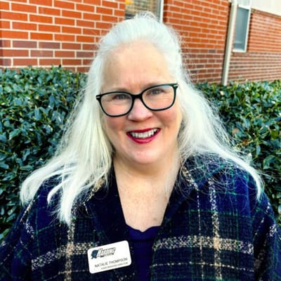 Staff member smiling outside the facility