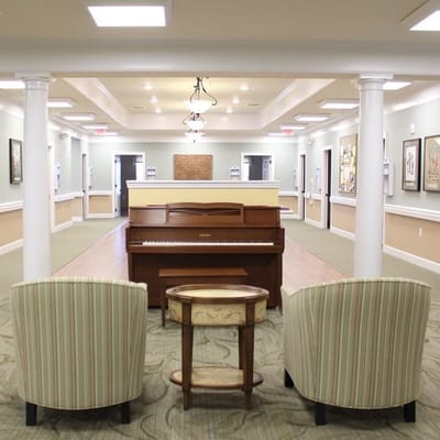 Common area with a piano and seating