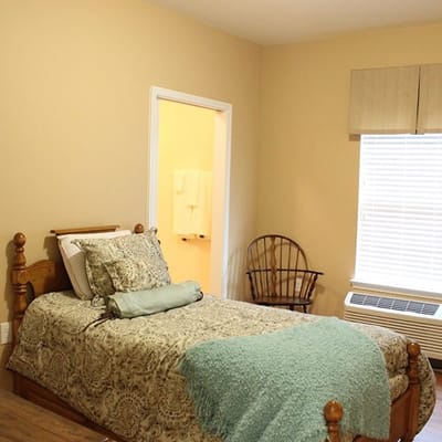 Cozy resident room with a bed and chair