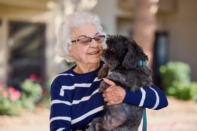 Resident enjoying time with a small dog