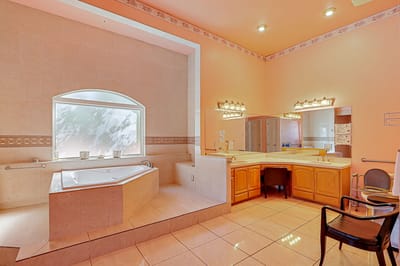 Spacious interior bathroom with a tub and sinks