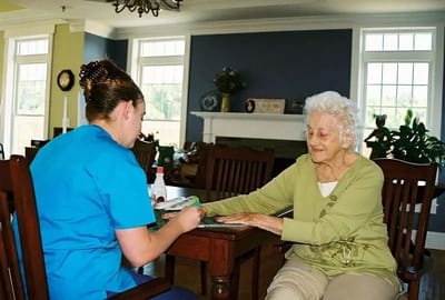 Staff member engaging with a resident at a table