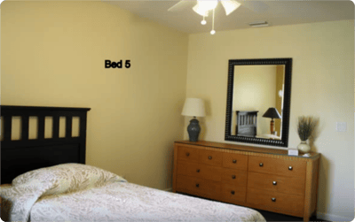 A cozy, well-lit resident bedroom with furniture