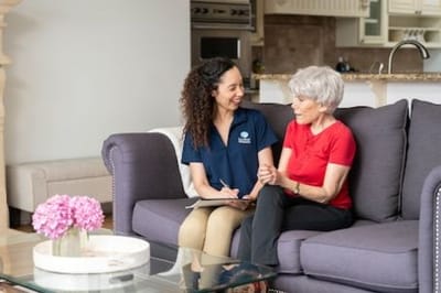 Caregiver interacting with a resident in a cozy living area