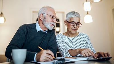 Two seniors engaged in an activity at a table