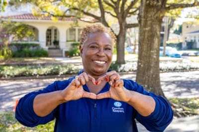 Staff member making a heart shape outdoors
