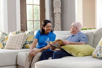 A caregiver interacting with a resident in a cozy living area