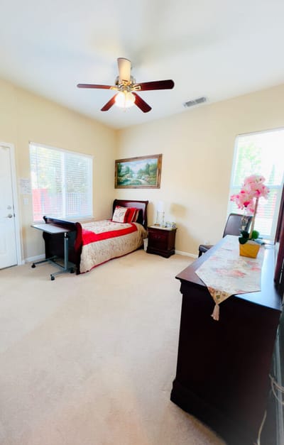 Bright and cozy resident room with a bed and decor