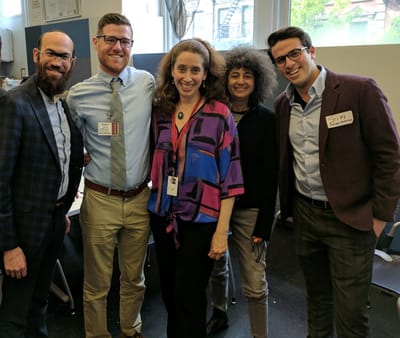 Staff members smiling together at an event