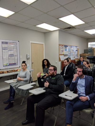Group of people seated in a classroom setting