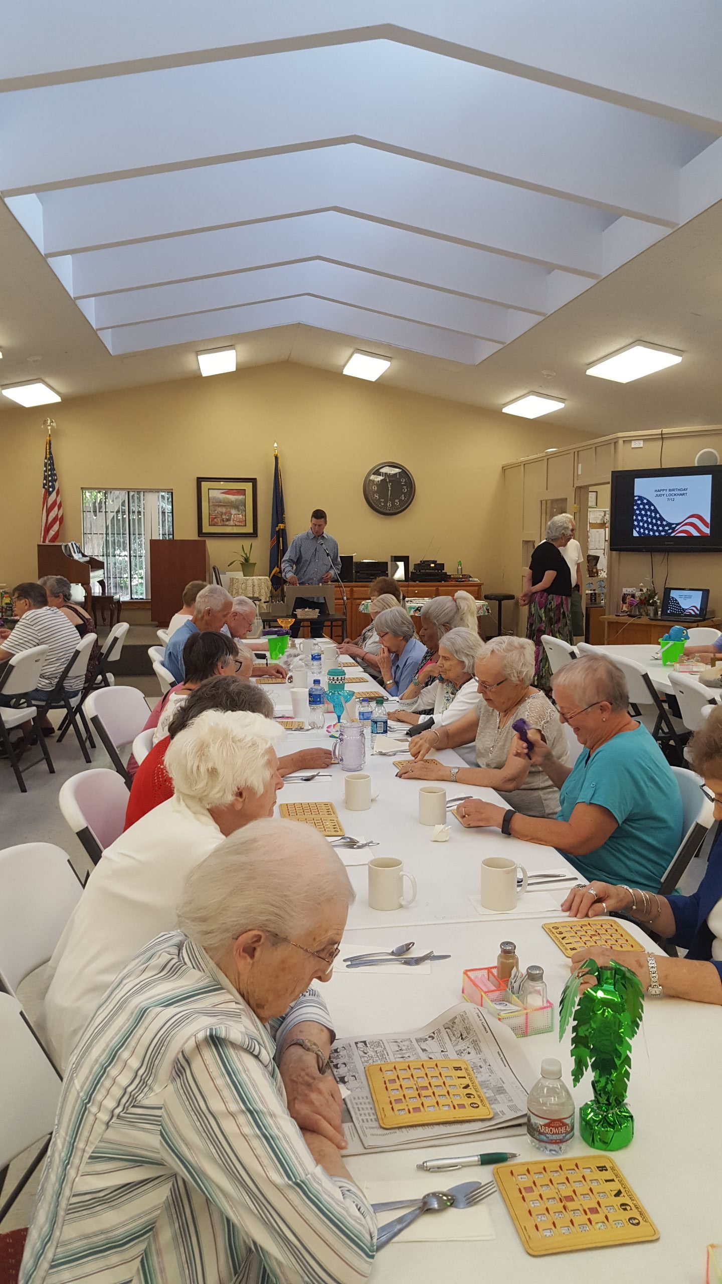 Residents enjoying bingo in a bright common area