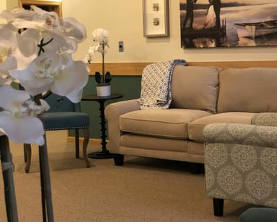 Cozy lounge area with a couch and flowers