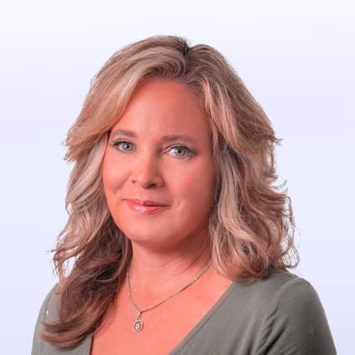Headshot of a woman with long hair in a professional setting