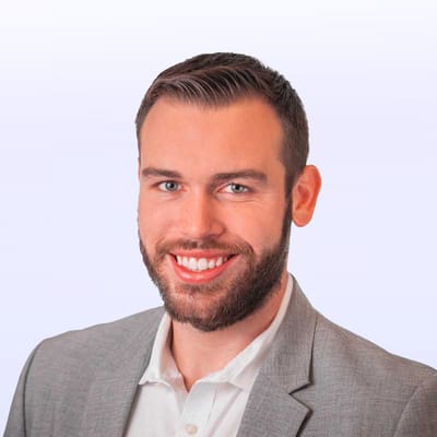 A professional headshot of a smiling man