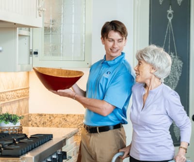 Caregiver and resident in a bright kitchen