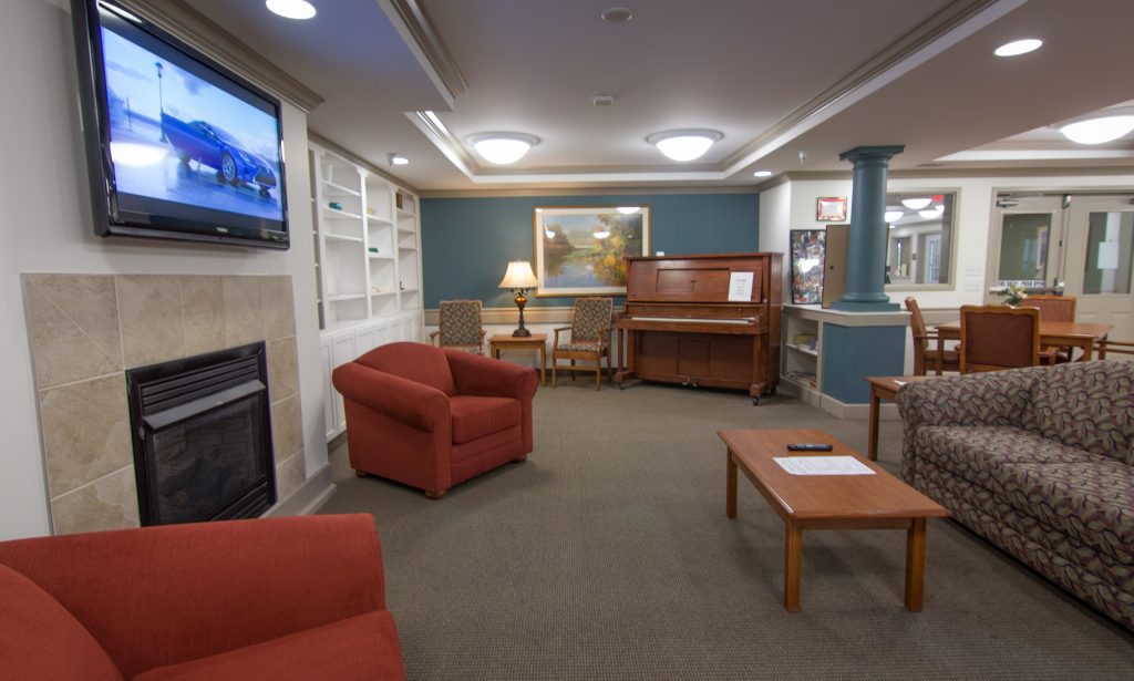 Bright common area with seating and piano