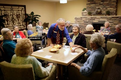 Residents enjoying snacks and conversation in a common area
