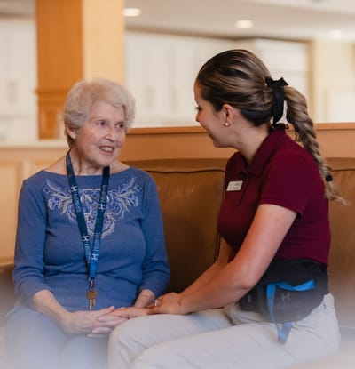 Resident engaging in conversation with staff member