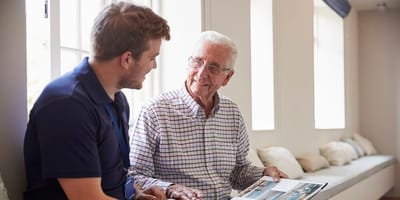 A staff member engaging with a resident in a comfortable setting