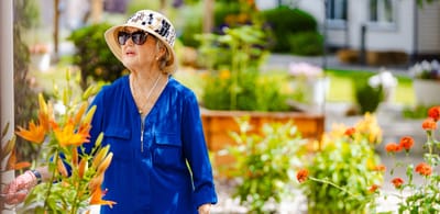 Resident enjoying flowers in the garden