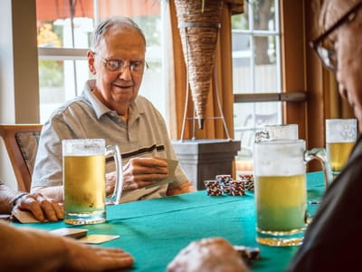 Residents engaged in a card game in a common area
