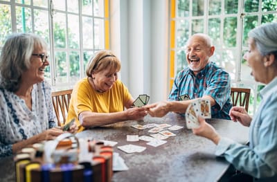 Residents enjoying a card game in a common area