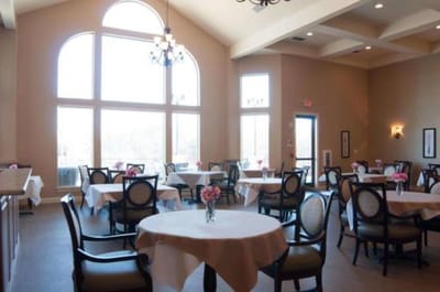 Bright dining room with tables and flowers