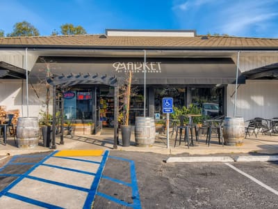 Exterior view of a market with outdoor seating