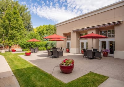 Outdoor patio area with umbrellas and seating