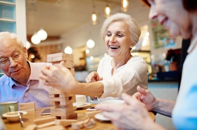 Residents enjoying a Jenga game in a common area