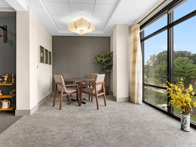 A cozy common area with a view of greenery