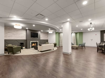 A common area in the facility with seating and a fireplace
