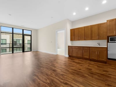 Bright interior view of a spacious room with kitchen area