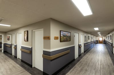 Interior hallway with room signs and artwork