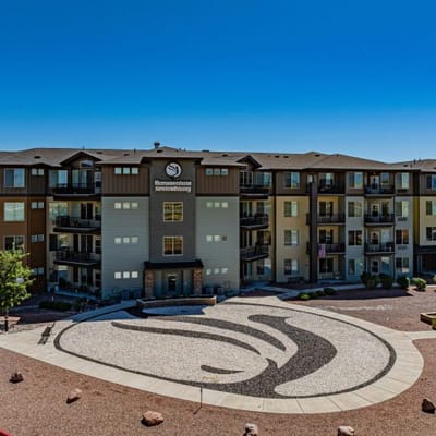 Exterior view of a senior living facility with landscaped area