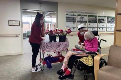 Residents and staff engaging in an activity with flowers