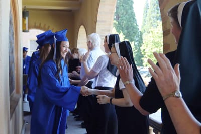 Students graduating and celebrating with staff members