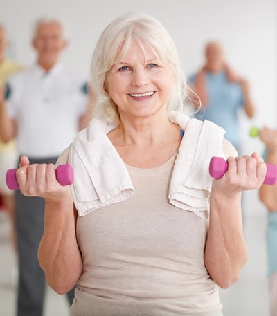 Active senior woman exercising with dumbbells