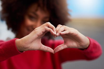 Heartland Hospice – Raleigh, hospice care in Raleigh, NC — Hands forming a heart shape against a blurred background