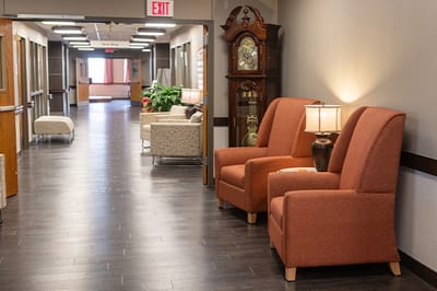Bright interior hallway with seating and decorative clock