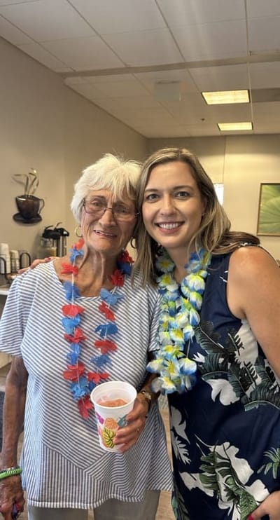 Residents celebrating with leis in a common area