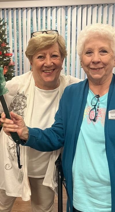 Two residents happily posing together inside the facility