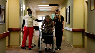 Timberlane Health & Rehab, assisted living in El Dorado, AR — Caregivers assisting a resident in a hallway
