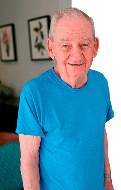 Elderly man smiling in a bright interior