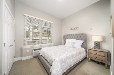 Cozy bedroom with a neatly made bed and natural light