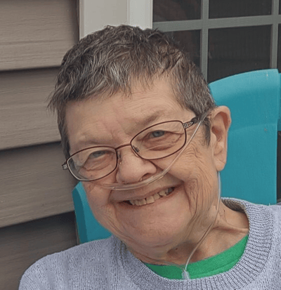 Smiling resident with glasses and oxygen tubing
