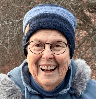 A joyful resident smiling in winter attire