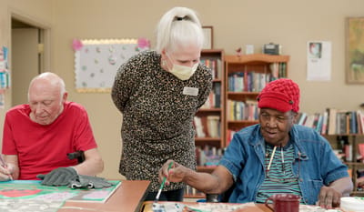 Residents engaging in arts and crafts activity with staff