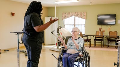 Timberlane Health & Rehab, assisted living in El Dorado, AR — Caregiver interacting with a resident in a common room